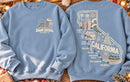 Santa's Surf Spots crewneck: Dawn Patrol December 25 front and California surf spots map back